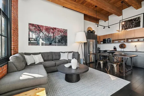 a living room with furniture and wooden floor