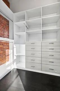 a view of walk in closet with empty racks