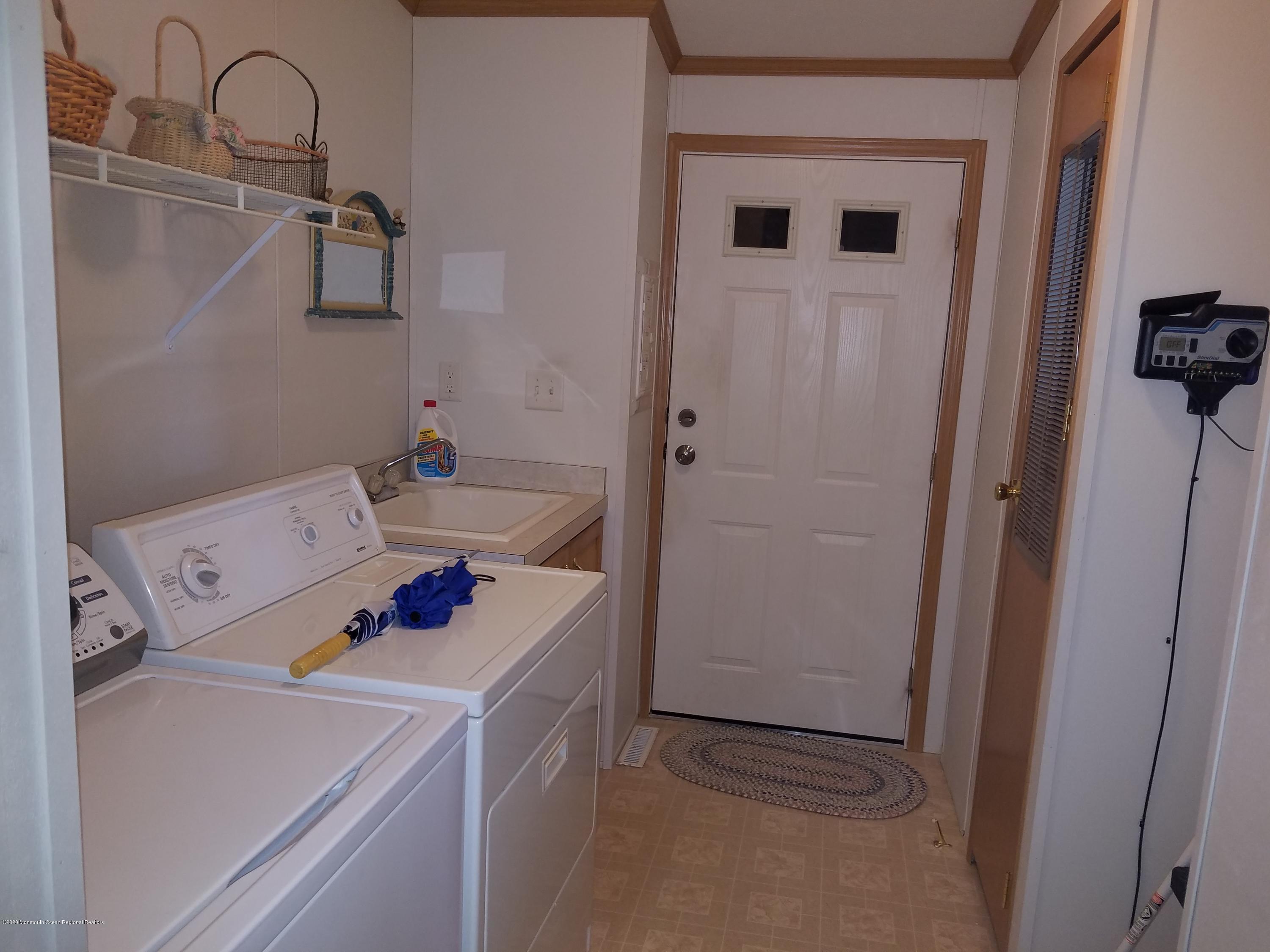74 Pine Ridge Boulevard Whiting, NJ 08759 - Photo 11 of 28 a storage room with washer and dryer