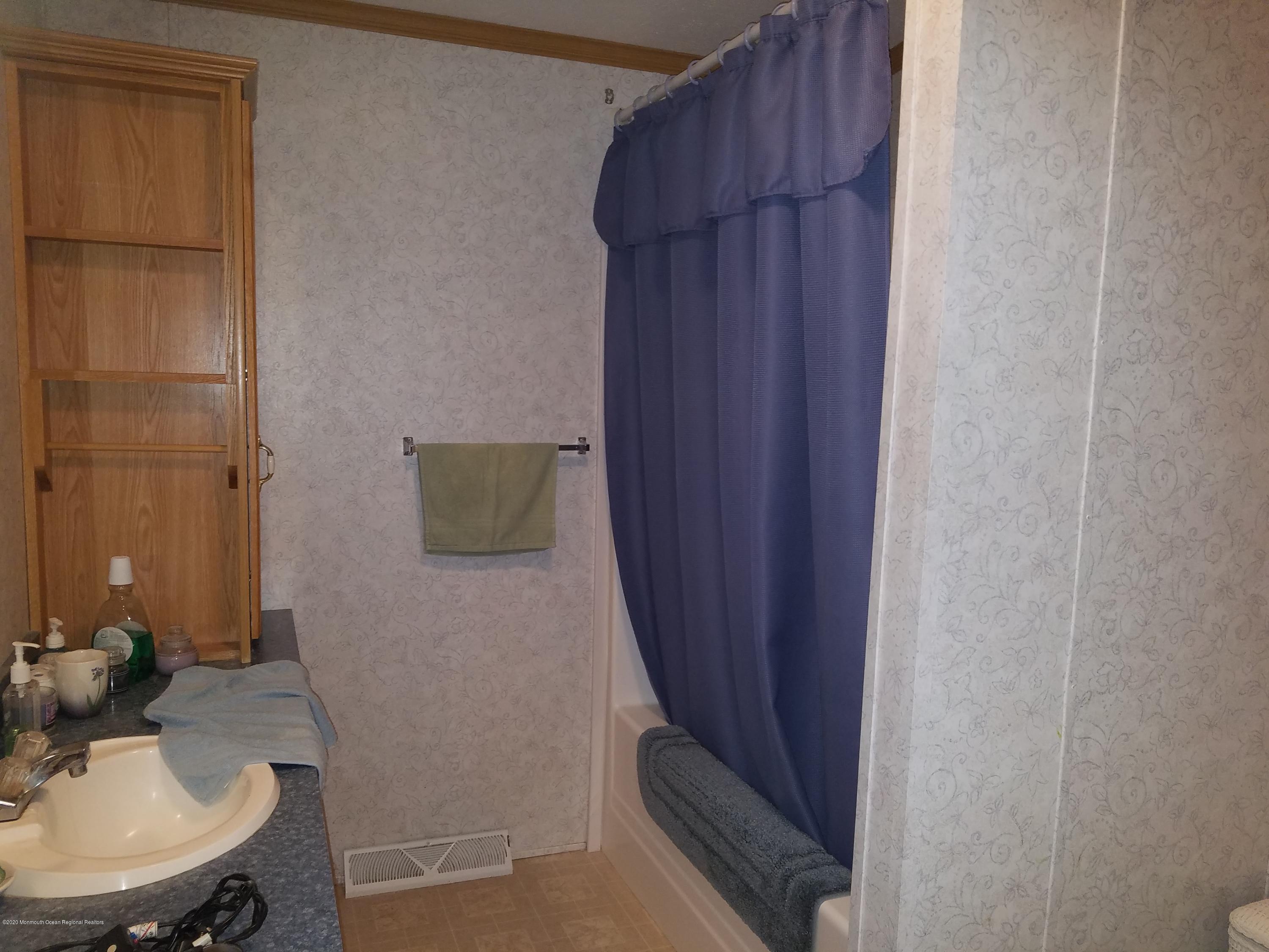 74 Pine Ridge Boulevard Whiting, NJ 08759 - Photo 12 of 28 a bathroom with a sink and a mirror