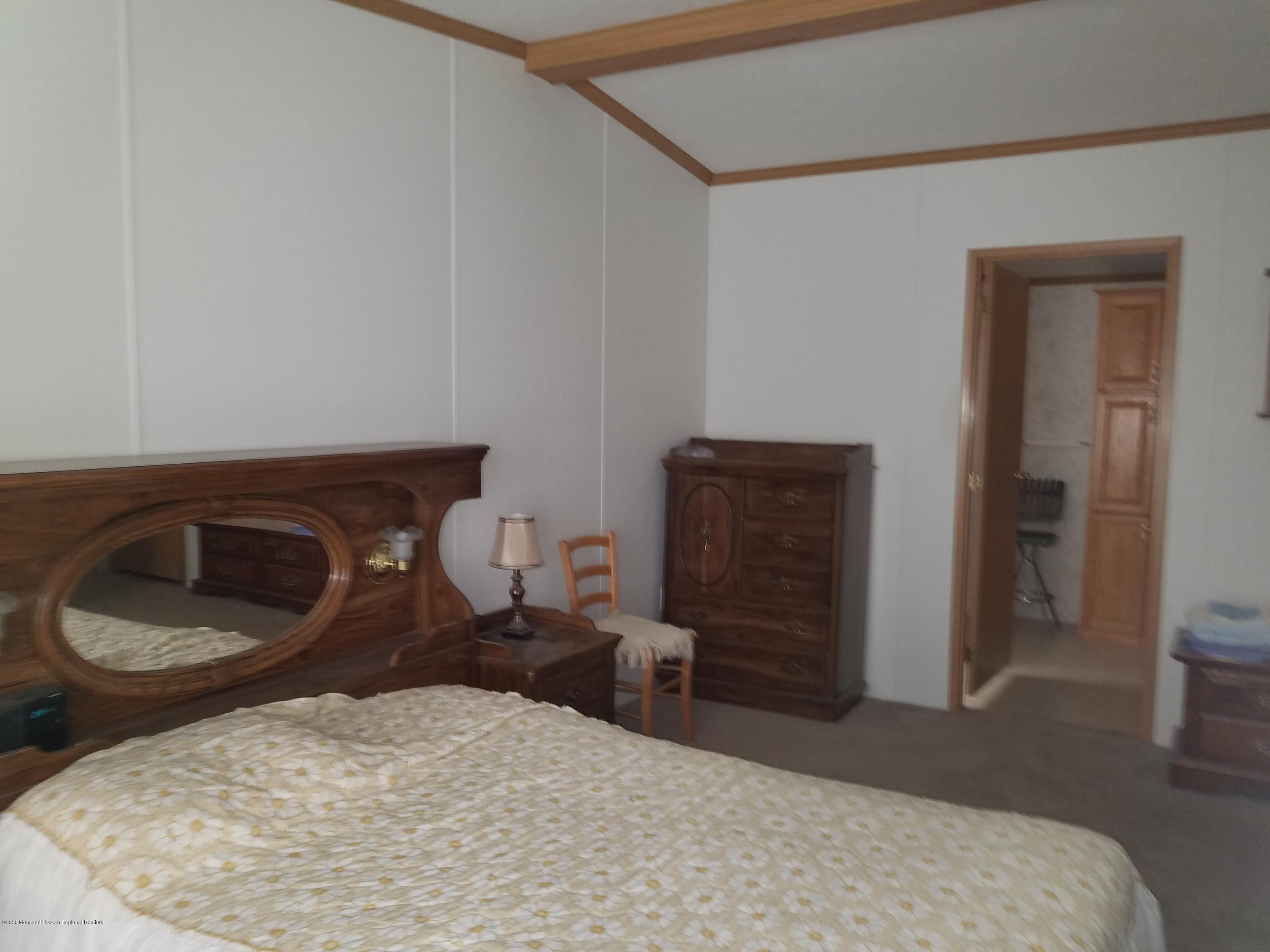 74 Pine Ridge Boulevard Whiting, NJ 08759 - Photo 15 of 28 a bathroom with a toilet and a chair