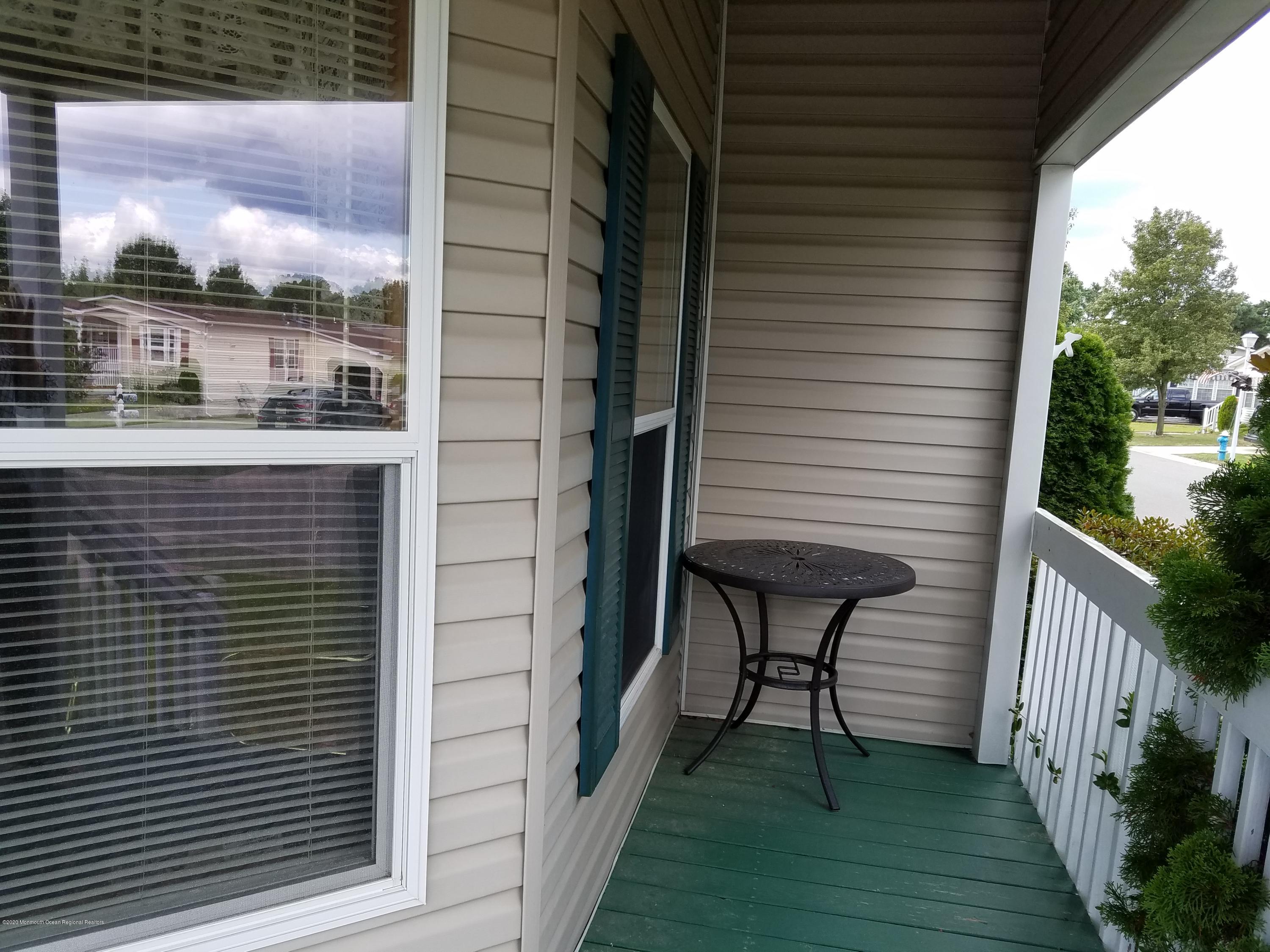 74 Pine Ridge Boulevard Whiting, NJ 08759 - Photo 2 of 28 a view of a balcony with furniture and wooden floor