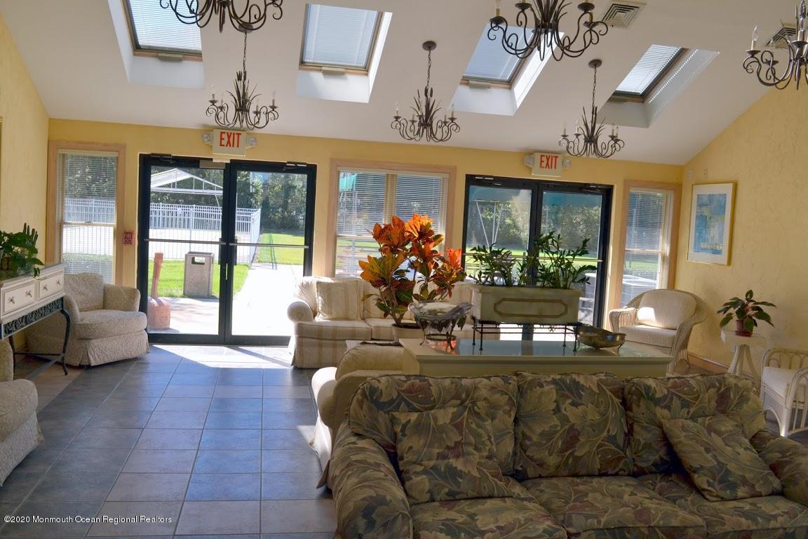 74 Pine Ridge Boulevard Whiting, NJ 08759 - Photo 22 of 28 a living room with furniture and a large window