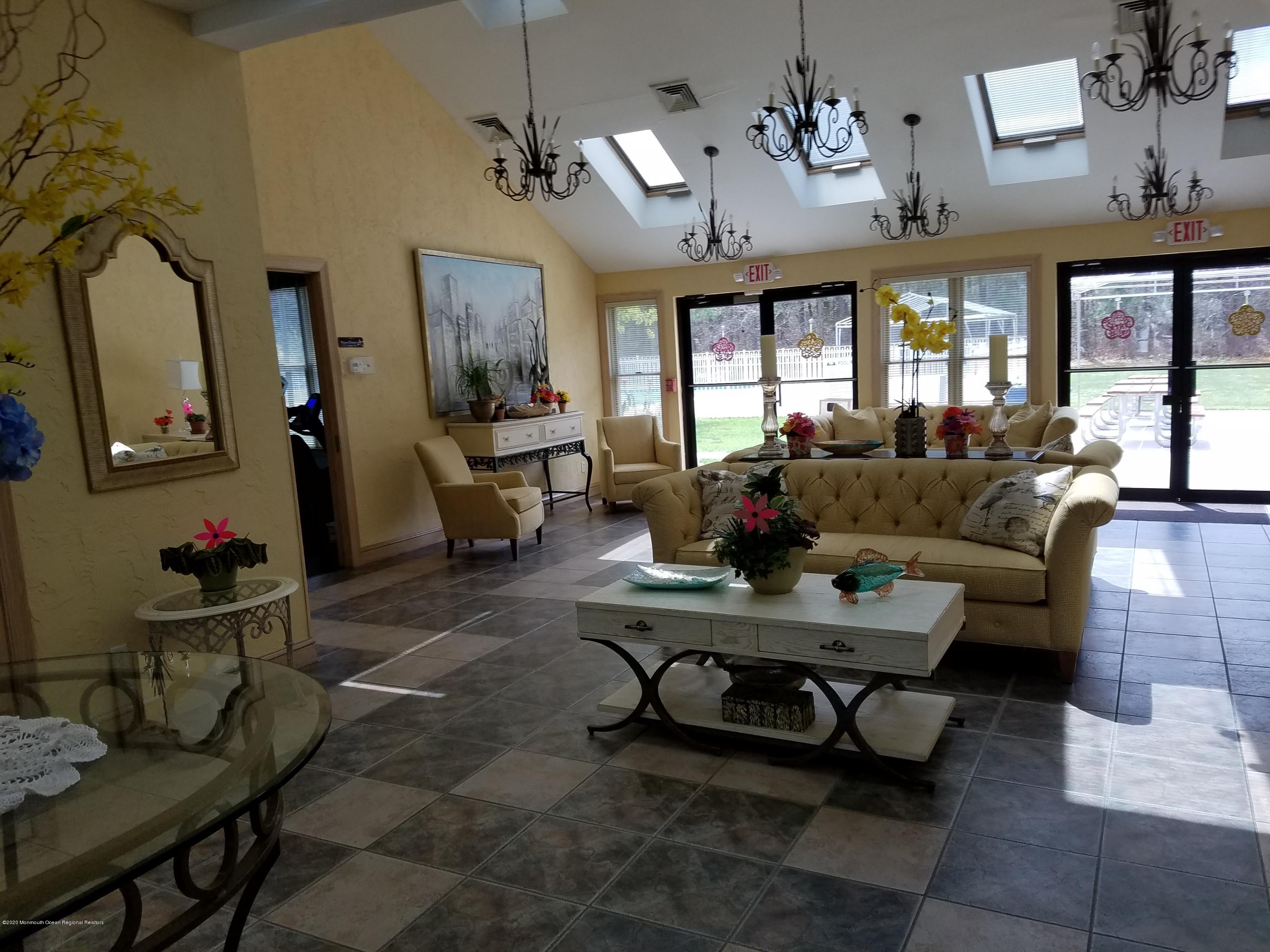 74 Pine Ridge Boulevard Whiting, NJ 08759 - Photo 23 of 28 a living room with furniture chess table and a window