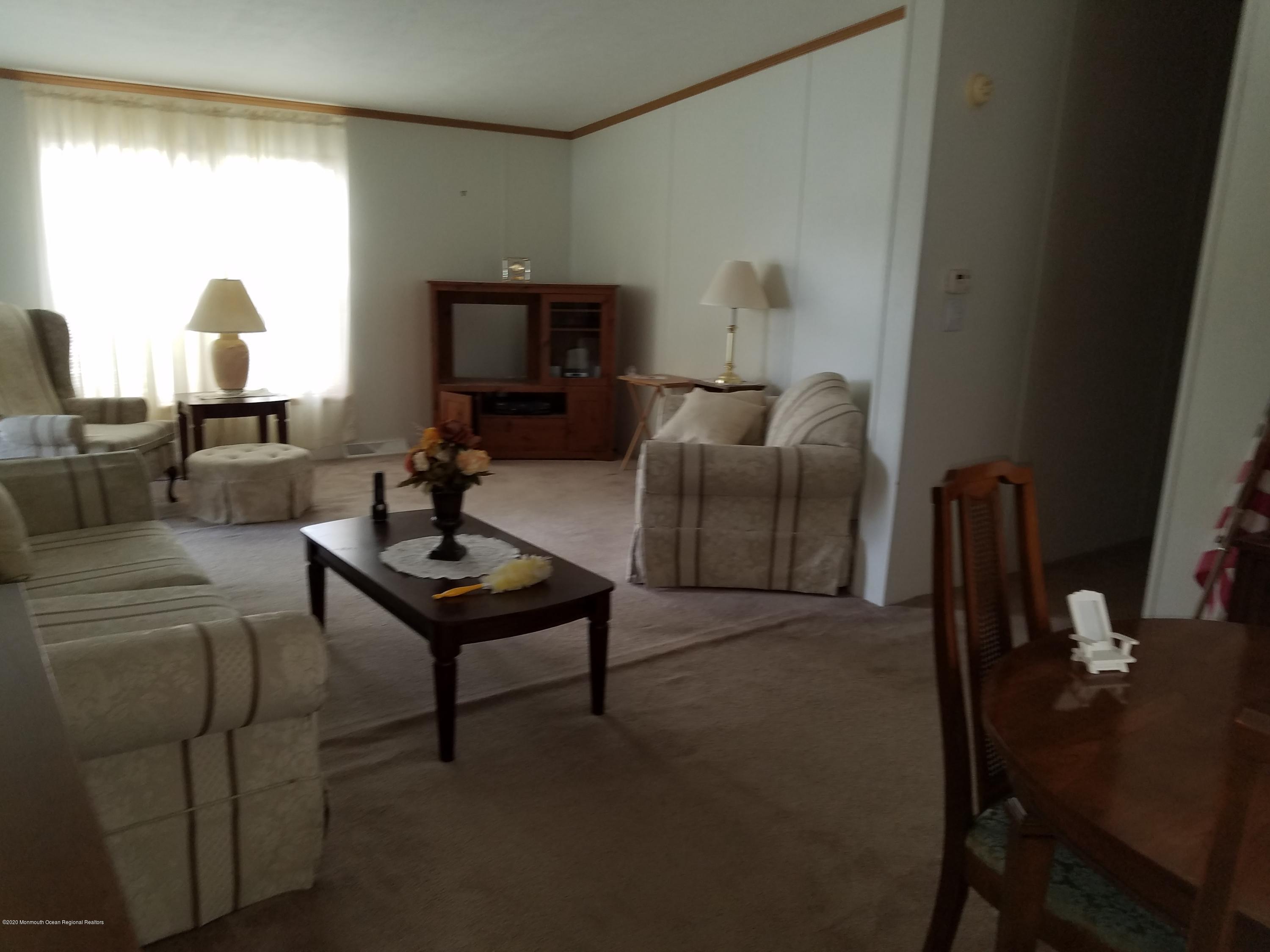 74 Pine Ridge Boulevard Whiting, NJ 08759 - Photo 4 of 28 a living room with furniture and a table