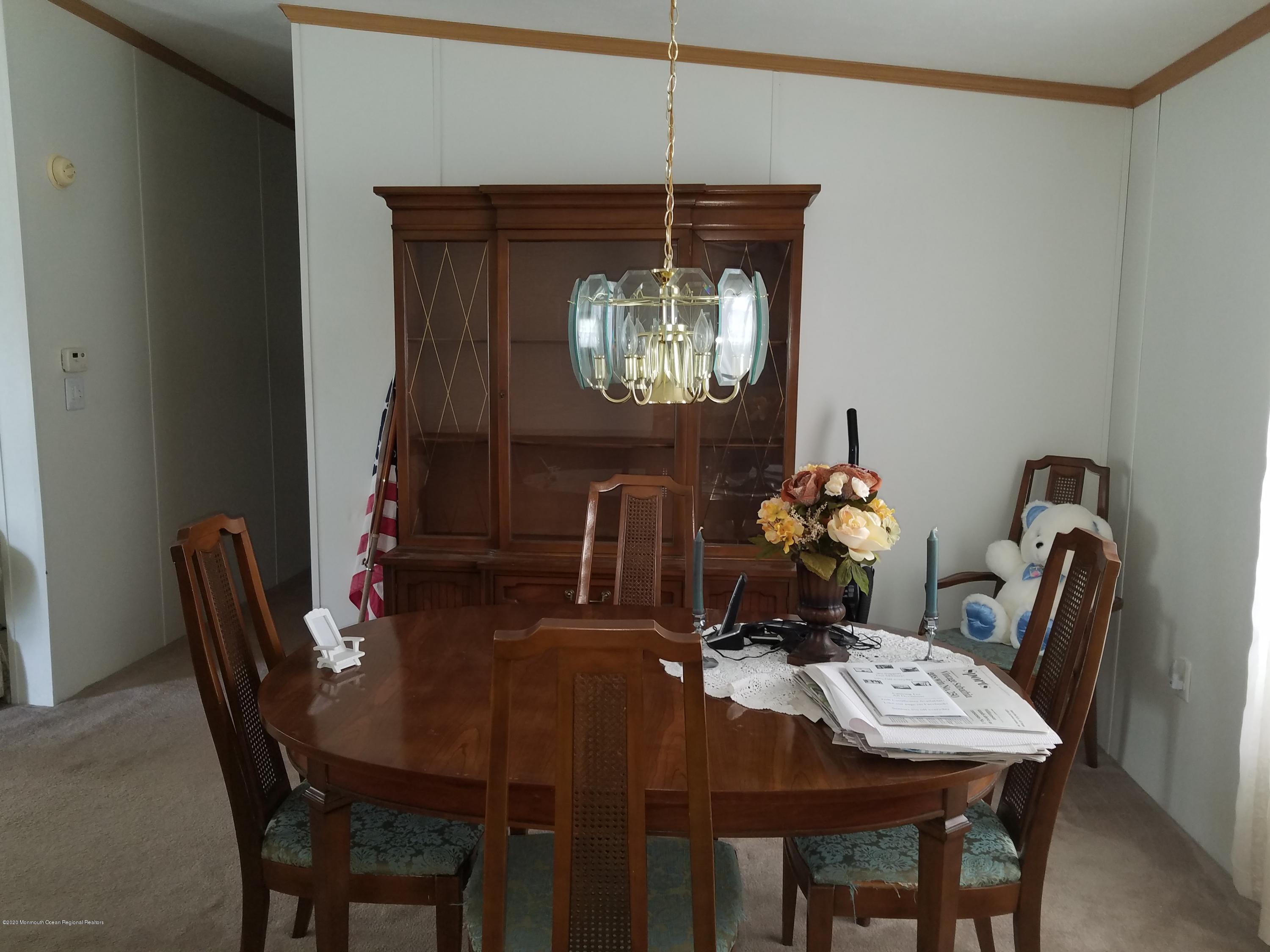 74 Pine Ridge Boulevard Whiting, NJ 08759 - Photo 5 of 28 a view of a dining room with furniture and chandelier