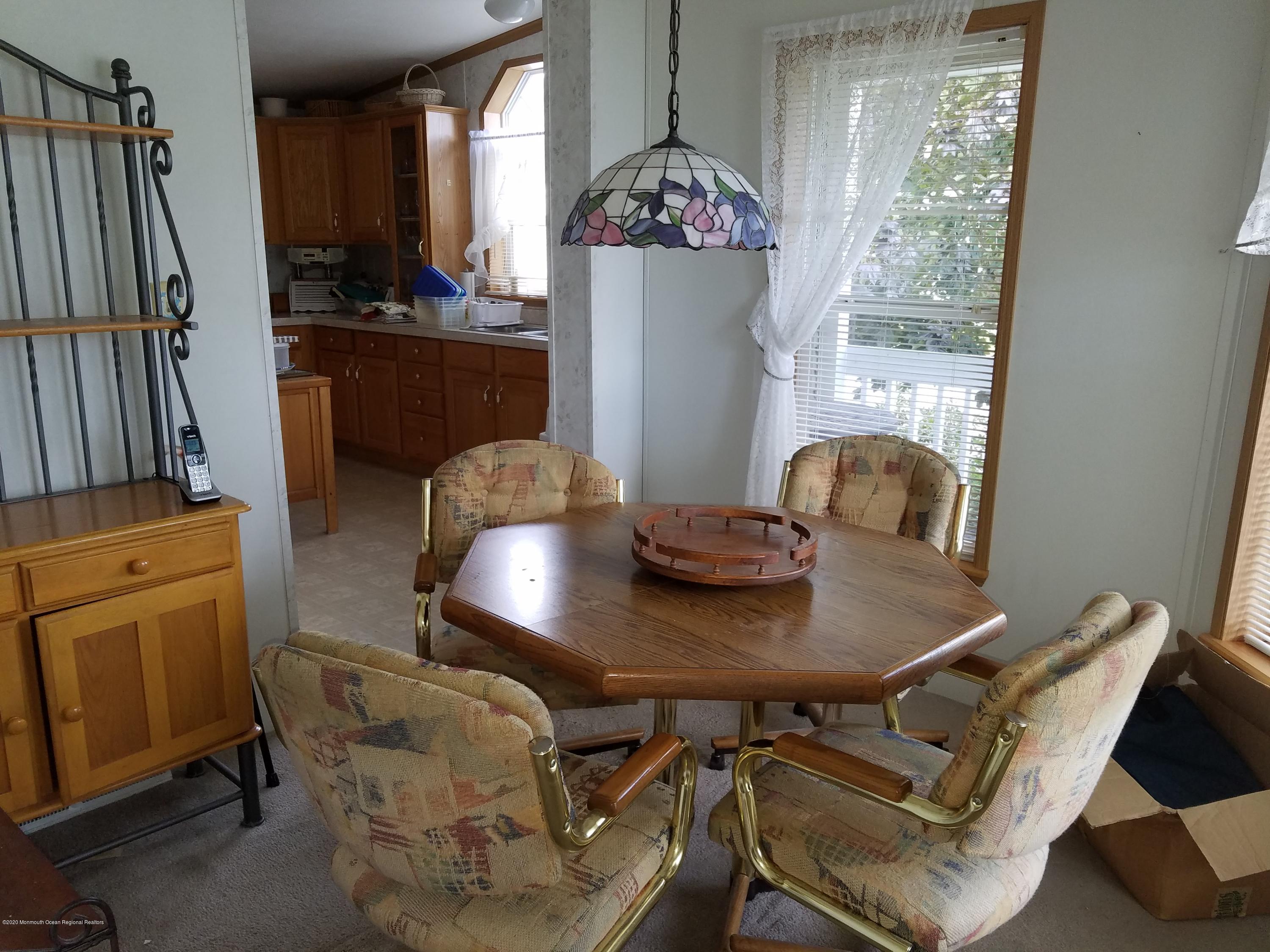 74 Pine Ridge Boulevard Whiting, NJ 08759 - Photo 6 of 28 a view of a dining room with furniture and a window