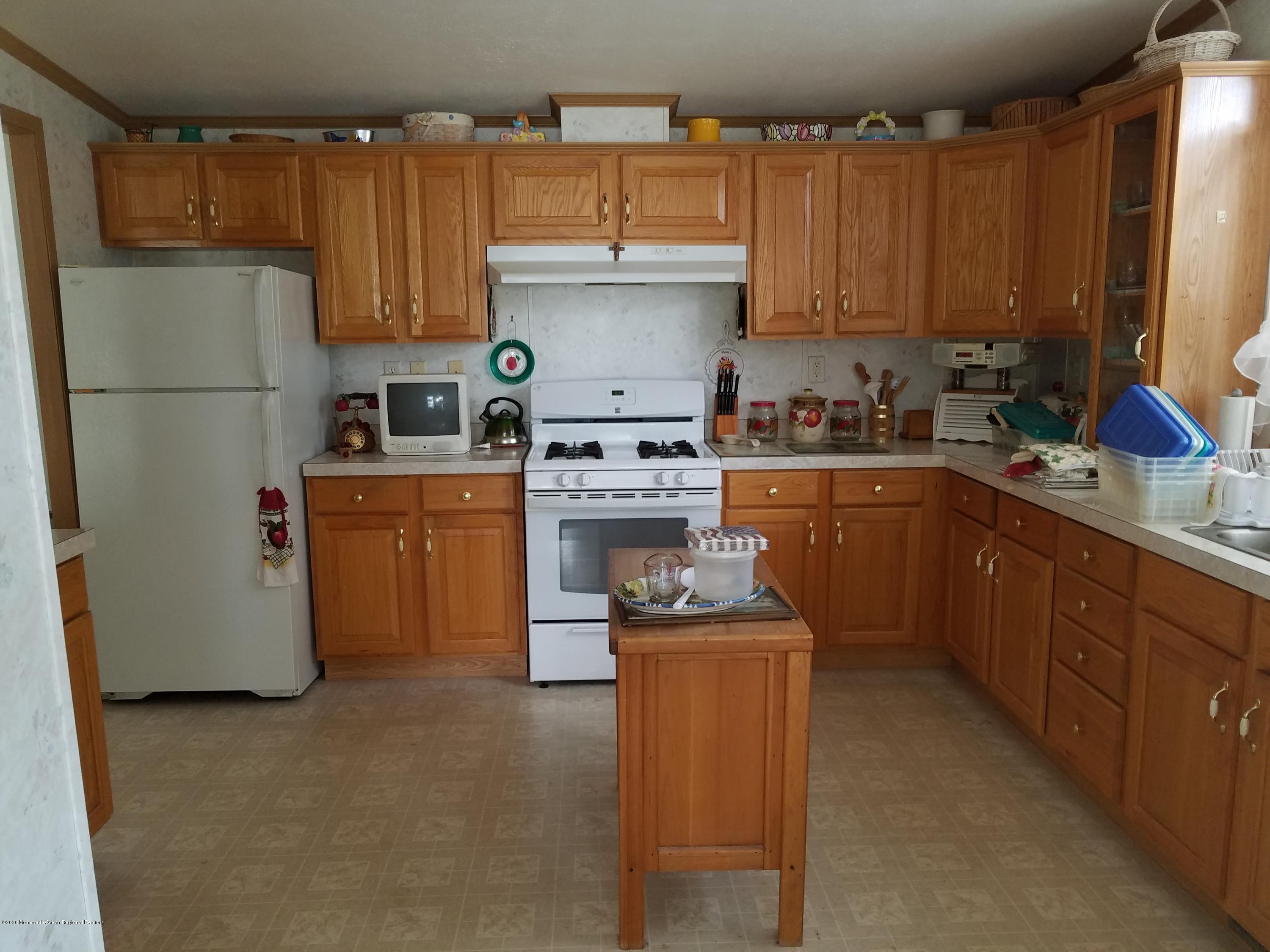 74 Pine Ridge Boulevard Whiting, NJ 08759 - Photo 8 of 28 a kitchen with cabinets appliances and a counter top space