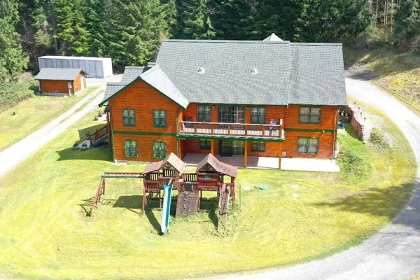 an aerial view of a house with a swimming pool