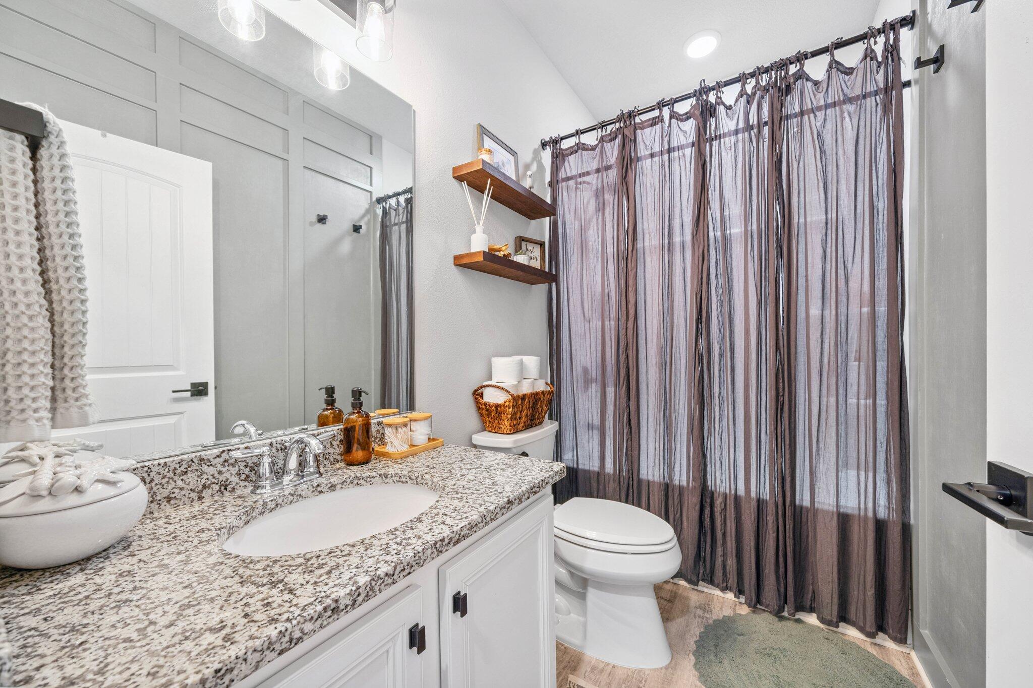 199 Southern Pnes Road Santa Rosa Beach, FL 32459 - Photo 28 of 44 a bathroom with a granite countertop sink and a mirror