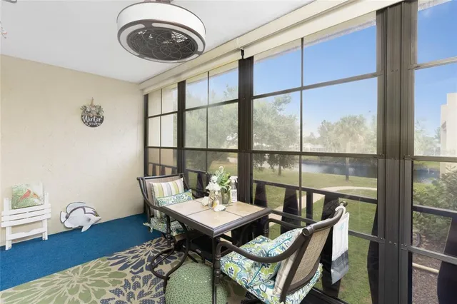 a living room with furniture and a floor to ceiling window