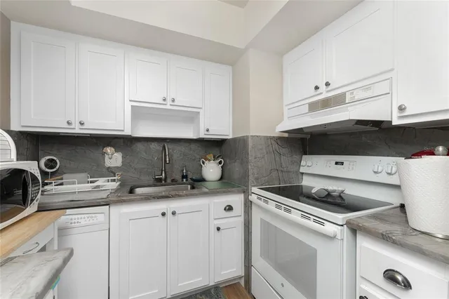 a kitchen with stainless steel appliances a stove a sink and a refrigerator
