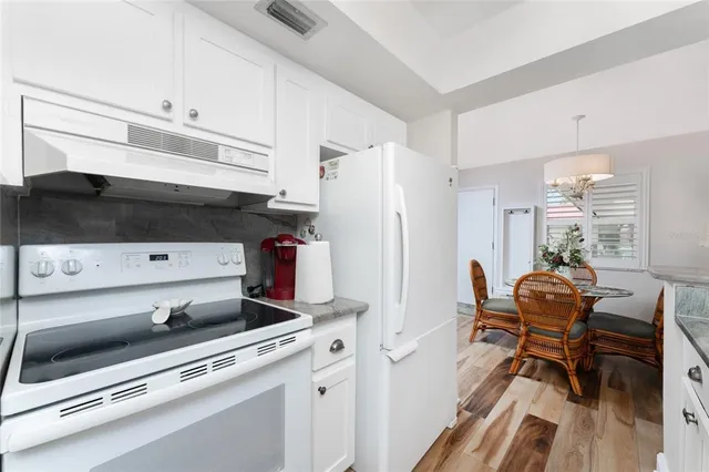 a bedroom with a bed and a flat tv screen on the dresser