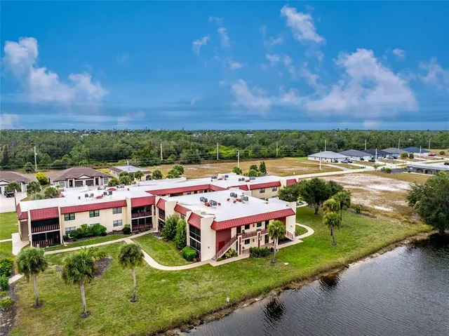 a view of a swimming pool with lounge chairs in patio