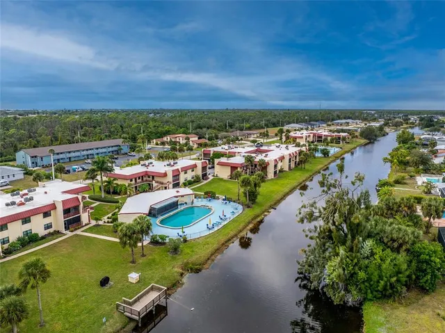 an aerial view of a house with a yard and lake view