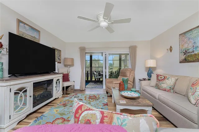 a living room with a table a table and a large window