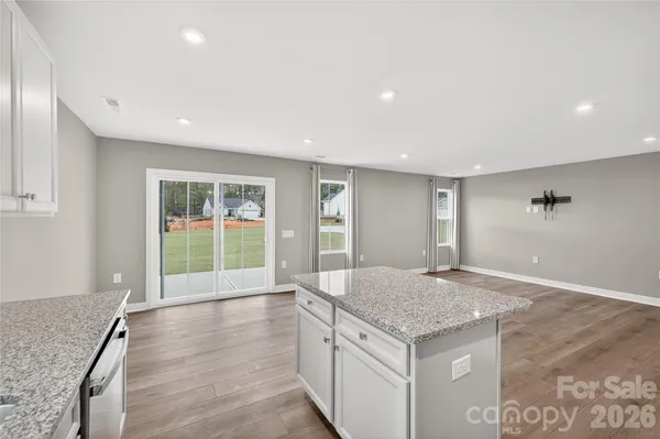 a view of an empty room with a kitchen