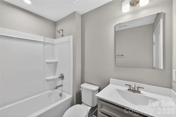 a bathroom with a sink toilet tub and shower