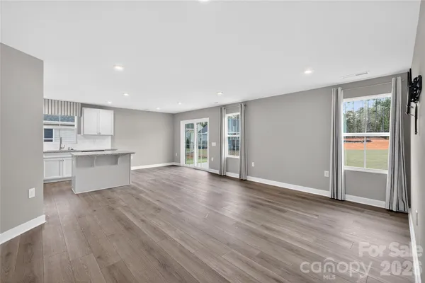 a view of a kitchen with wooden floor and a kitchen