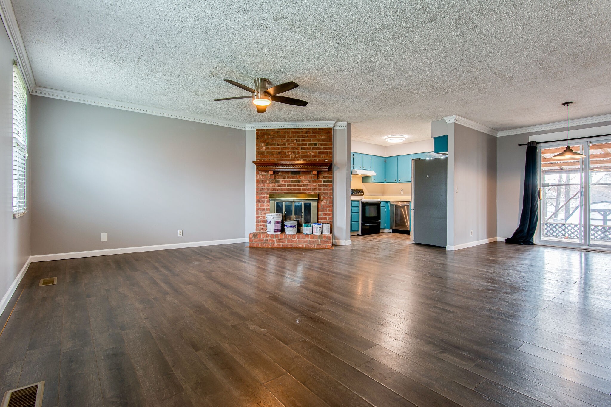 3309 Country Way Road Antioch, TN 37013 - Photo 5 of 26 an empty room with wooden floor fireplace and window