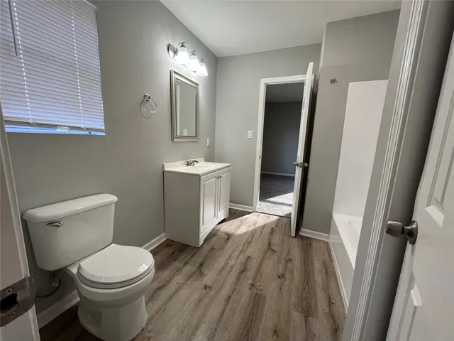 a white toilet sitting next to a bathroom sink