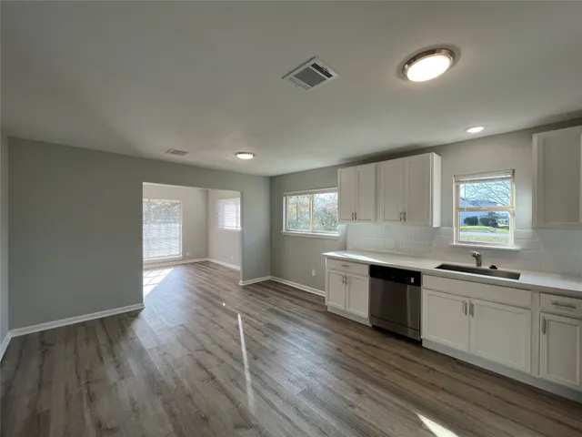 a view of a kitchen counter space wooden floor and windows