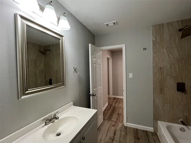 a bathroom with a sink a mirror and a shower