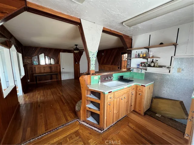 a kitchen with stainless steel appliances granite countertop a stove and a wooden floors