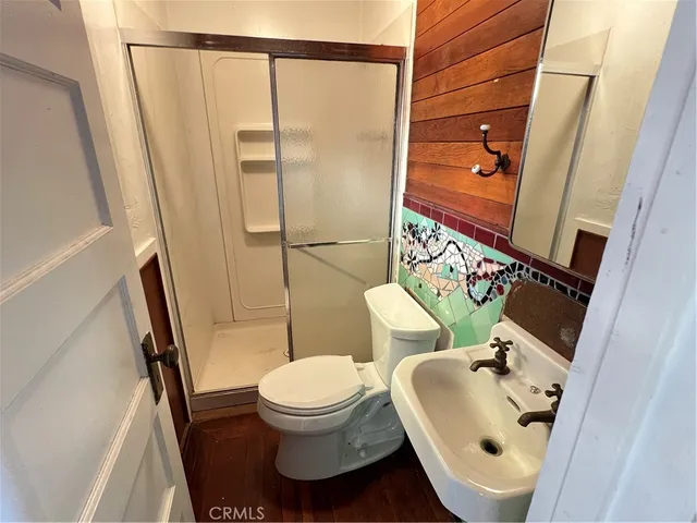a white toilet sitting next to a bathroom sink