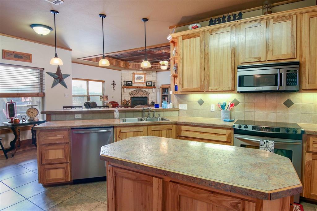 7158 Luella Road Sherman, TX 75090 - Photo 6 of 40 a kitchen with stainless steel appliances granite countertop a sink a stove counter space and cabinets