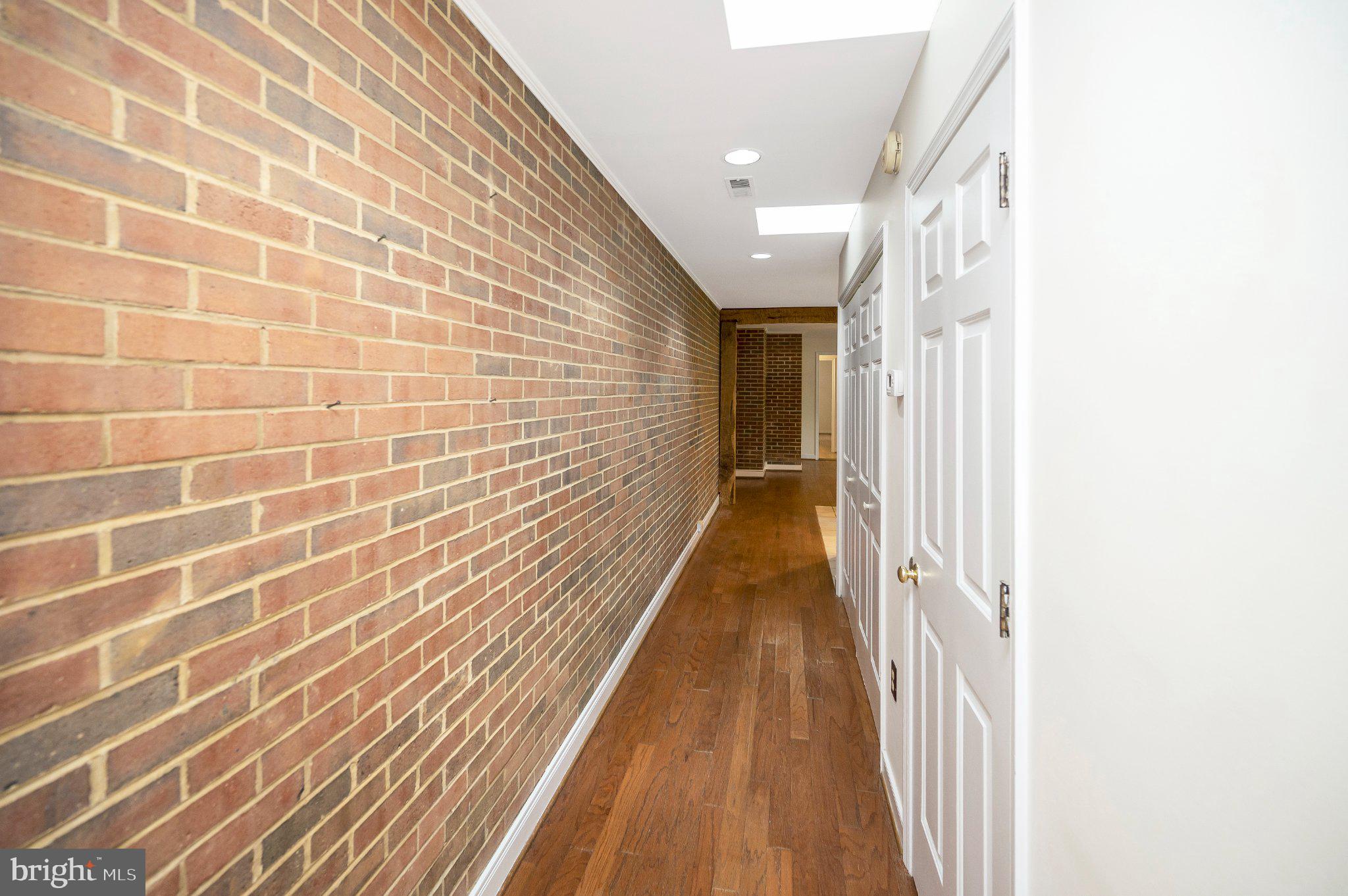 130 Springwood Drive, Unit RENTAL Fredericksburg, VA 22401 - Photo 12 of 39 Charming hallway with rustic brick walls.