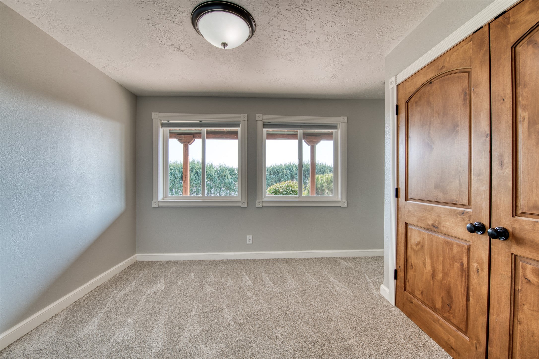 16374 Folsom Road Florence, MT 59833 - Photo 90 of 98 Unfurnished bedroom with light carpet, a textured ceiling, and a closet