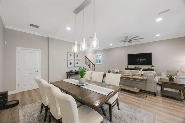 a large kitchen with stainless steel appliances lots of counter space and wooden floor