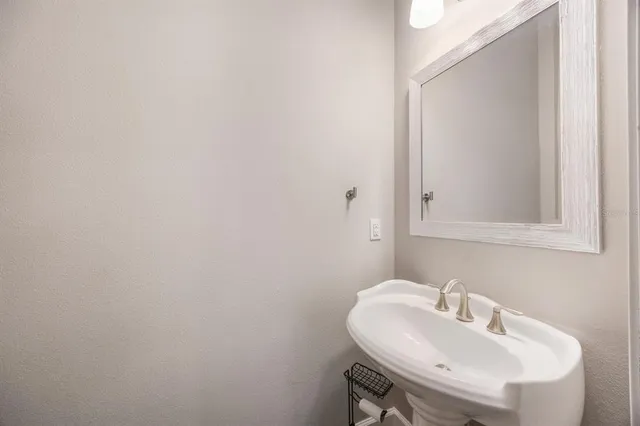 a kitchen with a refrigerator a sink dishwasher a stove and white cabinets with wooden floor