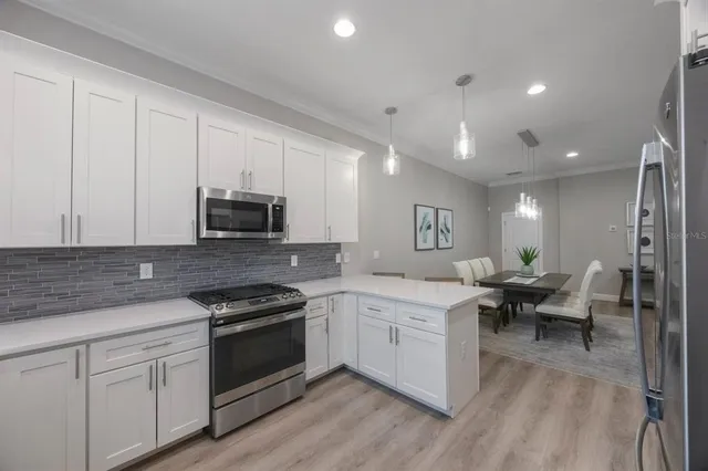 a view of a hallway with wooden floor and stairs