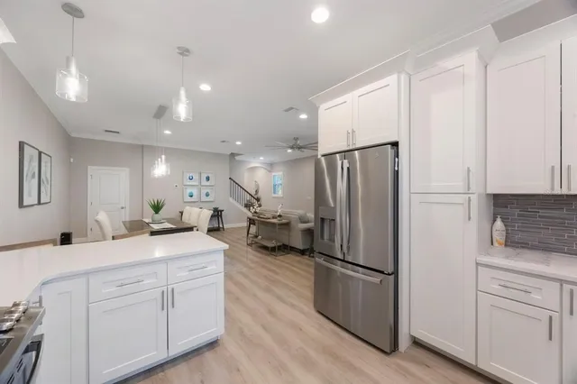 a view of a hallway with a livingroom and a dinning room with furniture