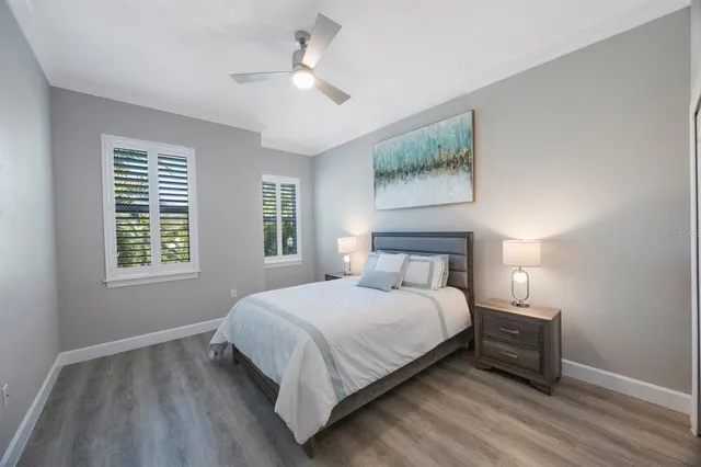 a bedroom with a bed and a ceiling fan