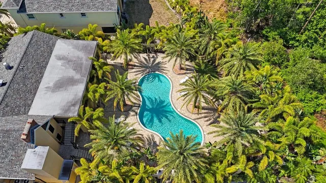 an aerial view of a house with a big yard and a garden