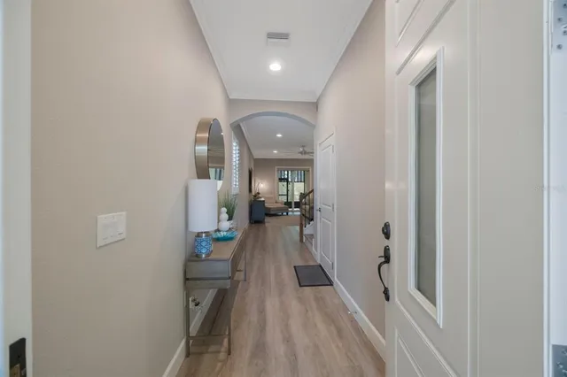 a view of a hallway with a livingroom and a bathroom with sink