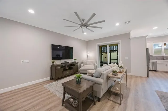 a living room with furniture and a wooden floor