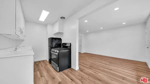 a kitchen with granite countertop a stove and a refrigerator