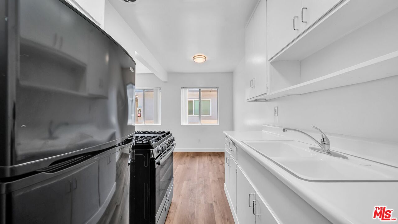 510 Pacific Avenue, Unit 6 Venice, CA 90291 - Photo 5 of 14 a kitchen with a sink and large windows