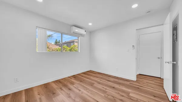 a view of room with wooden floor and window