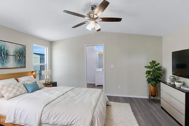 a bedroom with a bed and a potted plant