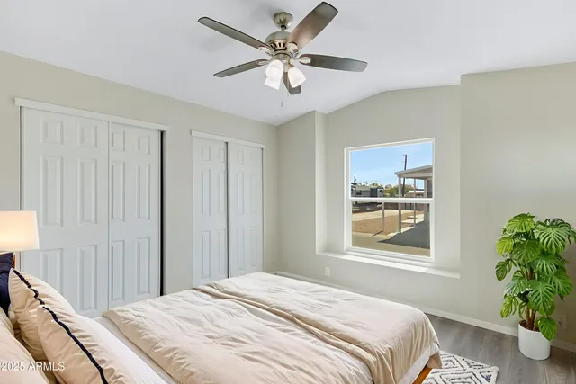 a bedroom with a bed and a window