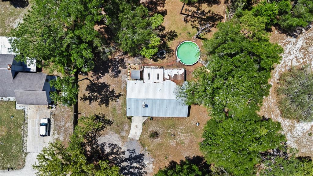 5420 East Gwendolyn Path Inverness, FL 34452 - Photo 39 of 42 an aerial view of a house with a yard and large trees