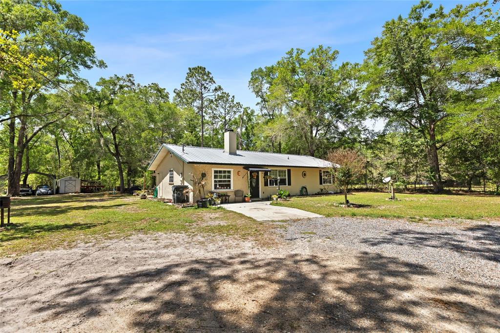 5420 East Gwendolyn Path Inverness, FL 34452 - Photo 5 of 42 a big room with big trees and a big yard
