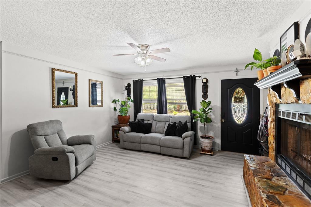 5420 East Gwendolyn Path Inverness, FL 34452 - Photo 6 of 42 a living room with furniture a fireplace a rug and a window