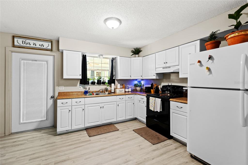 5420 East Gwendolyn Path Inverness, FL 34452 - Photo 9 of 42 a kitchen with white cabinets and white appliances