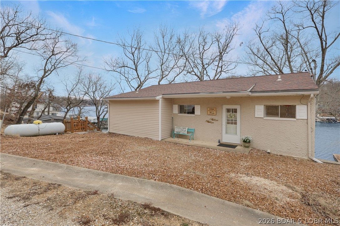 29966 Oak Knoll Road Rocky Mount, MO 65072 - Photo 34 of 59 View of home from roadside. Gravel parking area ac